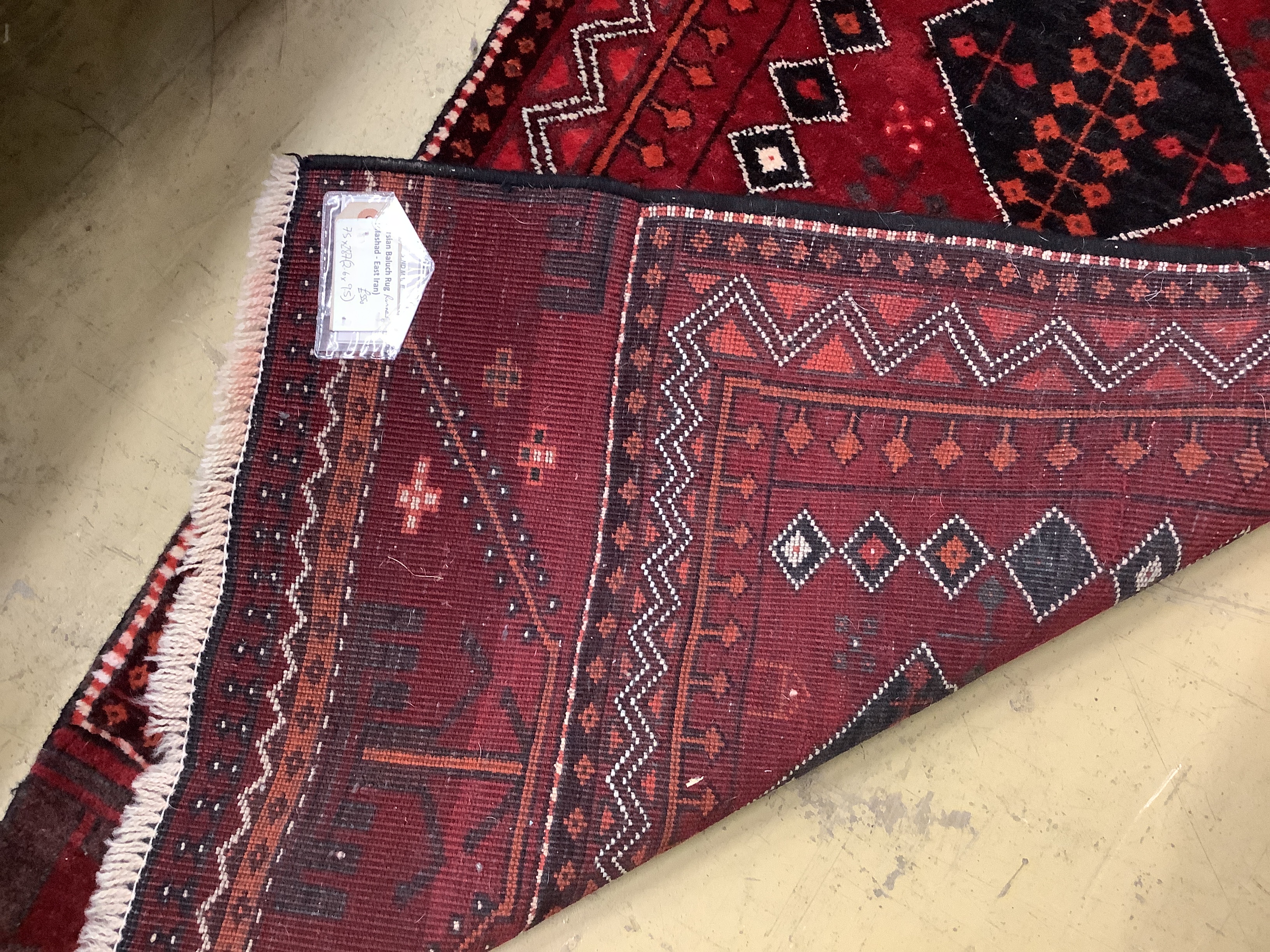 A Turkish burgundy ground runner, 286 x 75cm